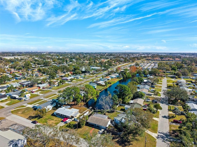 drone / aerial view with a water view and a residential view