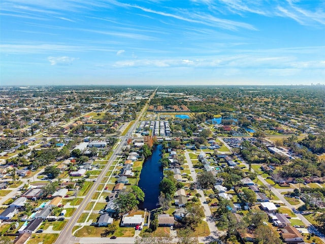 drone / aerial view with a water view and a residential view