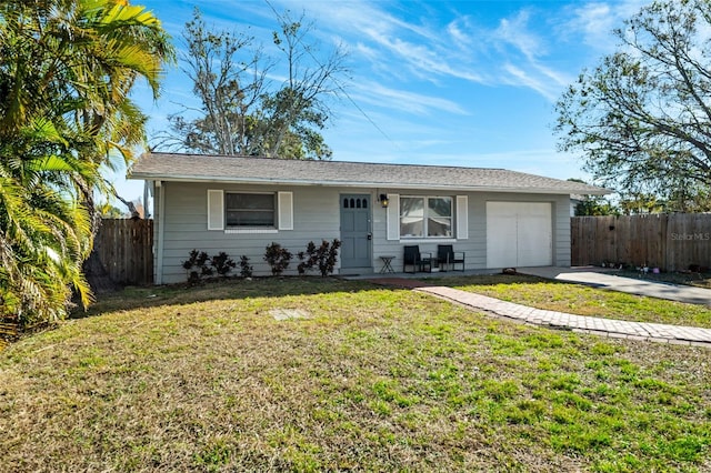 single story home featuring an attached garage, fence, driveway, and a front lawn