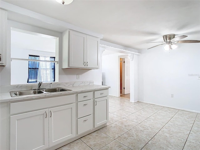 kitchen with white cabinetry, sink, and light tile patterned floors