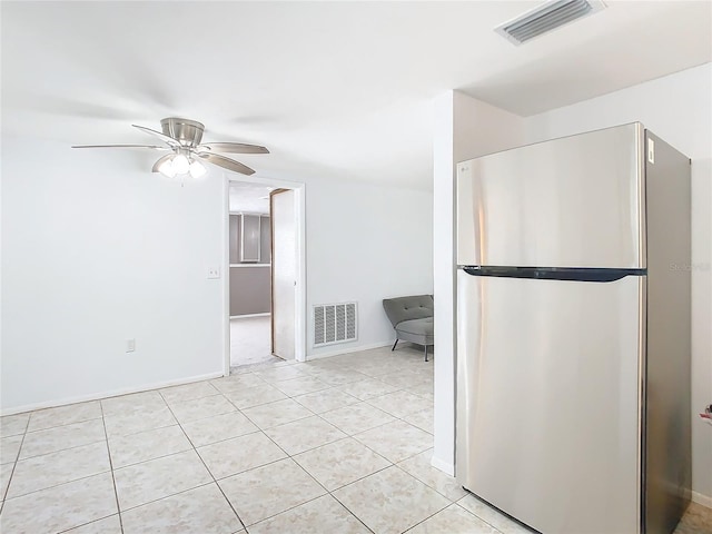 kitchen featuring light tile patterned floors, stainless steel fridge, and ceiling fan