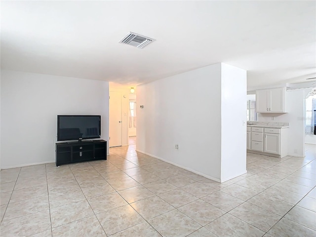 unfurnished living room featuring light tile patterned floors