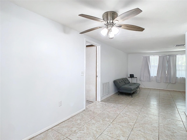 unfurnished room featuring ceiling fan and light tile patterned floors