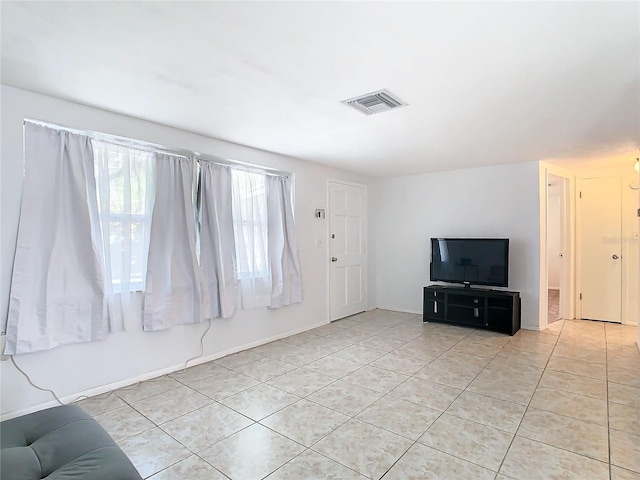 unfurnished living room with light tile patterned floors