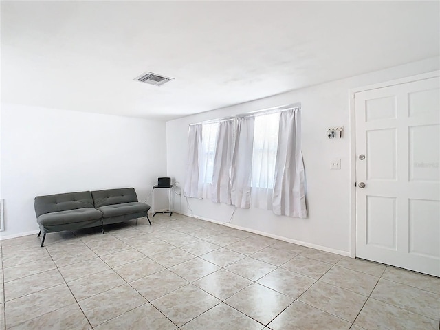 unfurnished room featuring light tile patterned floors