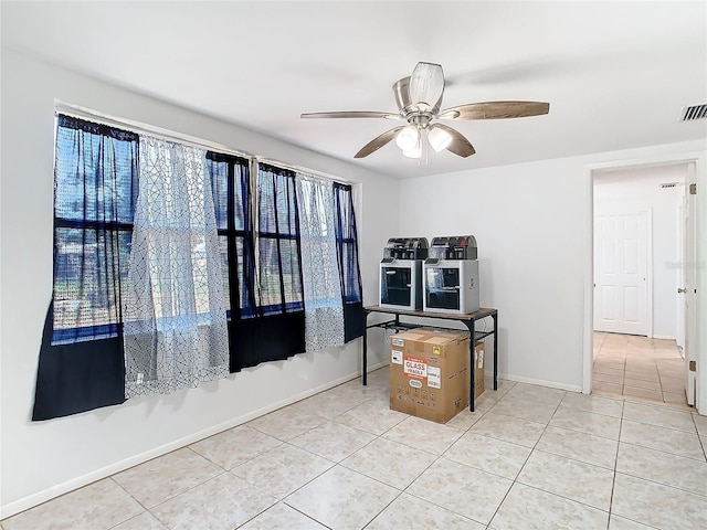 interior space featuring ceiling fan and light tile patterned flooring