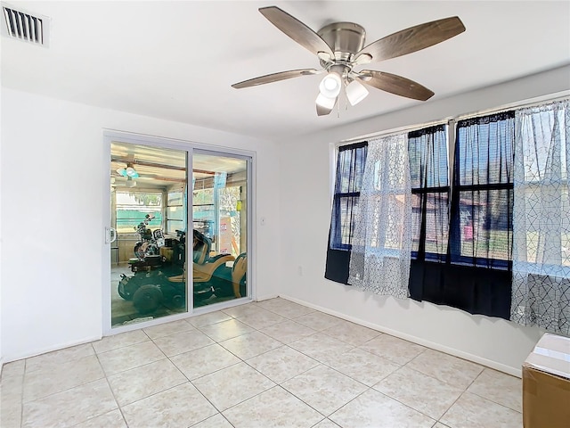 spare room featuring tile patterned flooring and ceiling fan