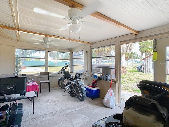 sunroom featuring beamed ceiling, ceiling fan, and plenty of natural light