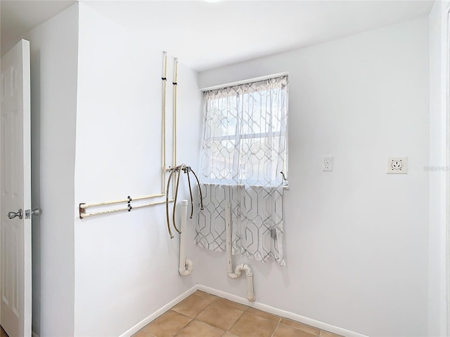 interior space featuring washer hookup, light tile patterned floors, and gas dryer hookup