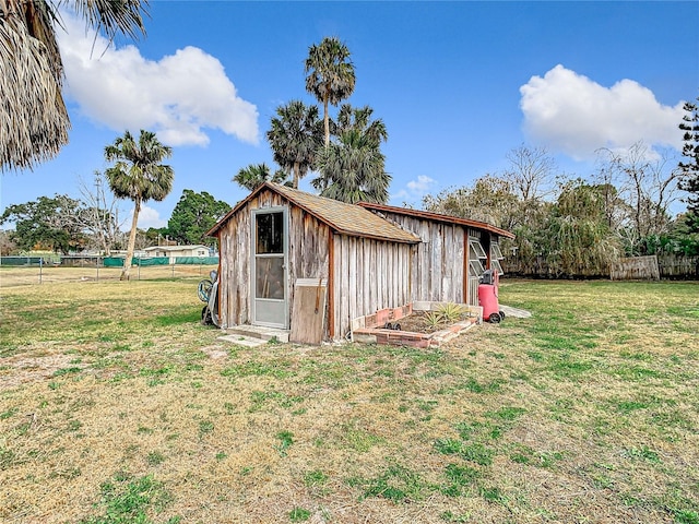 view of outbuilding featuring a lawn