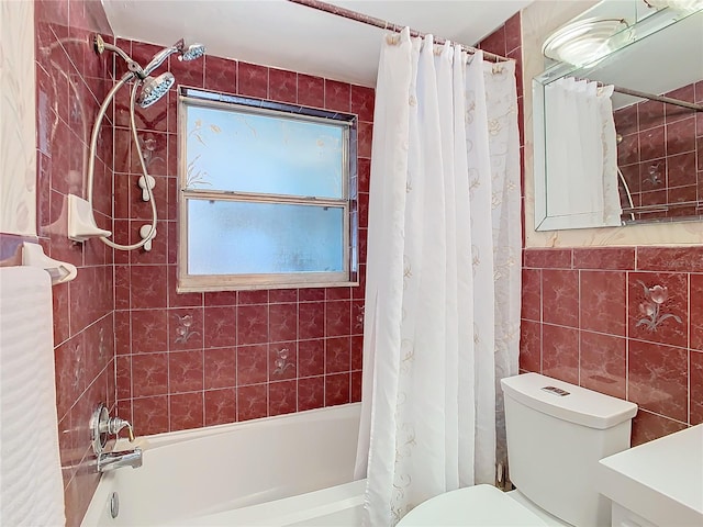 bathroom with tile walls, shower / bath combination with curtain, and toilet