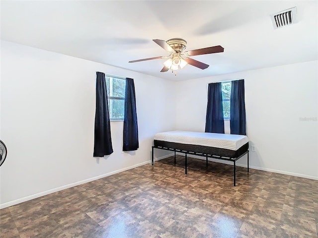 bedroom featuring ceiling fan and multiple windows