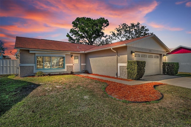 ranch-style home with a garage and a lawn