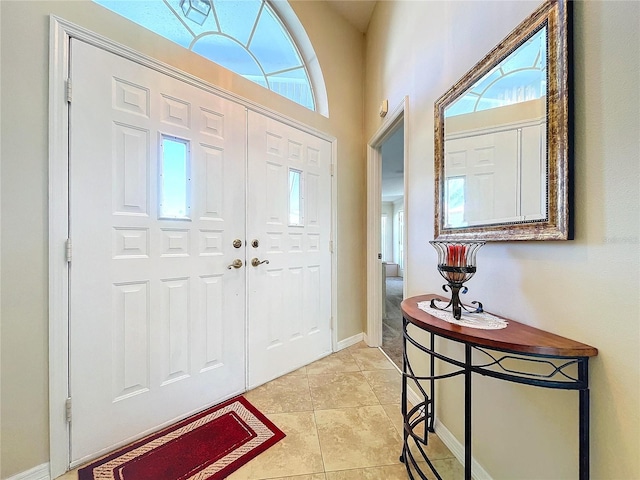 entrance foyer with baseboards and light tile patterned flooring