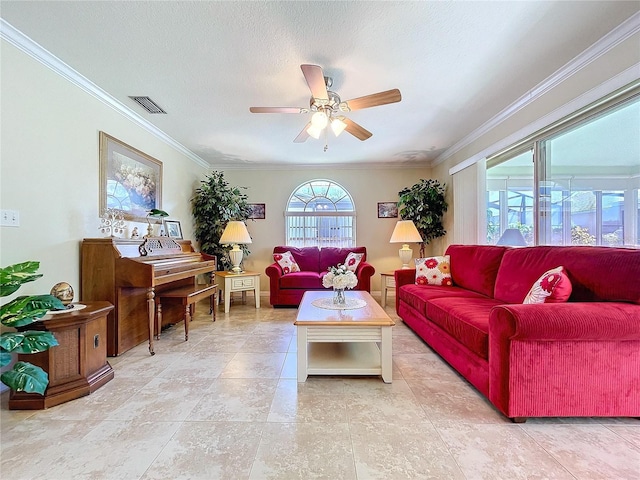 living area featuring ceiling fan, ornamental molding, a textured ceiling, and visible vents