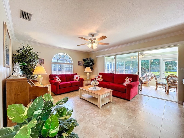 living room featuring ornamental molding, light tile patterned floors, visible vents, and a ceiling fan