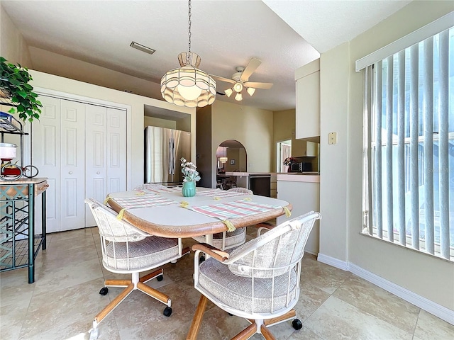 dining area with a healthy amount of sunlight, ceiling fan, visible vents, and baseboards