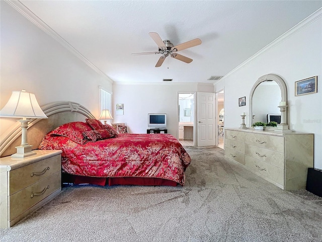 carpeted bedroom with a ceiling fan, connected bathroom, visible vents, and crown molding