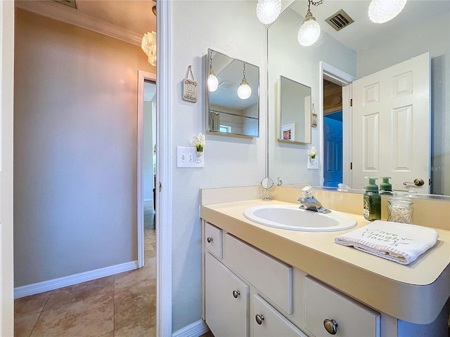 bathroom featuring visible vents, ornamental molding, vanity, tile patterned flooring, and baseboards