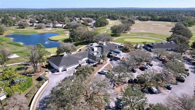 drone / aerial view with golf course view, a water view, and a residential view