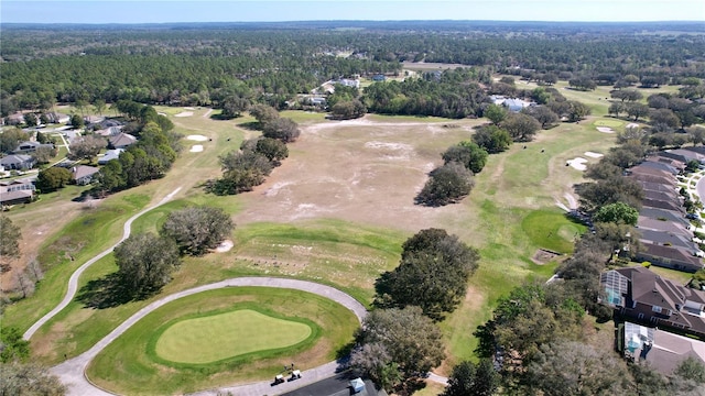 birds eye view of property featuring view of golf course and a view of trees