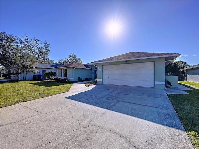 single story home featuring driveway, a front lawn, an attached garage, and stucco siding