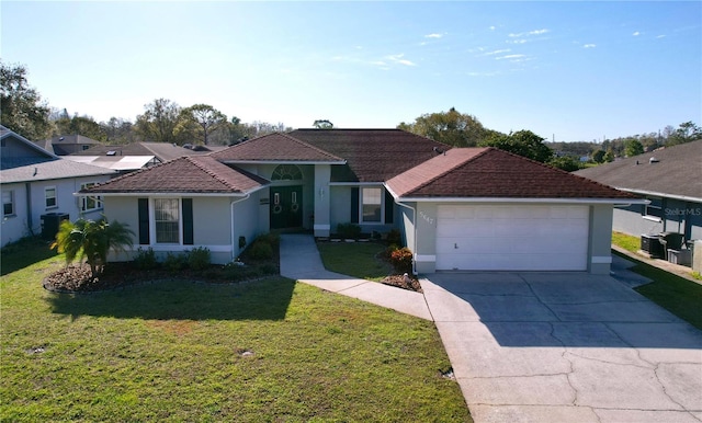 view of front of home with a garage, concrete driveway, a front lawn, central AC, and stucco siding