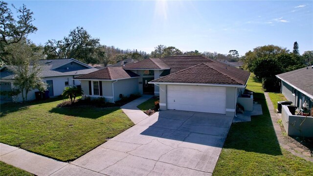 single story home featuring a garage, driveway, a front lawn, and stucco siding