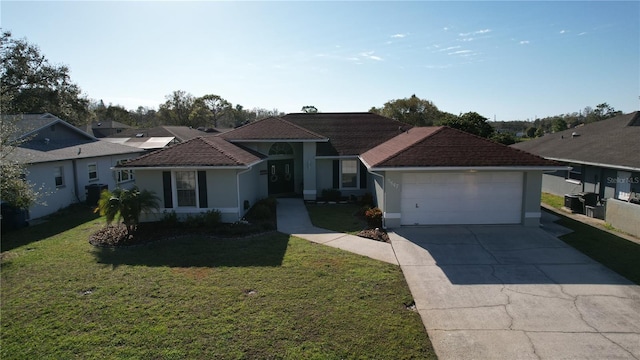 view of front of home with a garage, driveway, a front lawn, and stucco siding