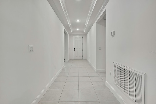 hallway featuring crown molding and light tile patterned flooring