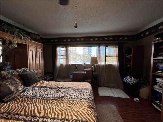 bedroom with crown molding, hardwood / wood-style flooring, and a textured ceiling