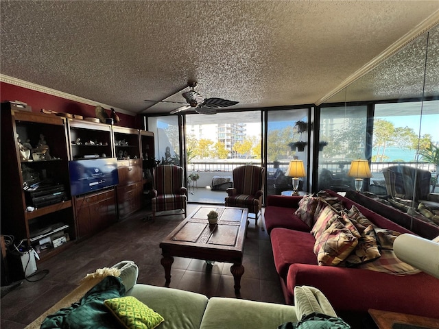 living room featuring ornamental molding, ceiling fan, and a textured ceiling