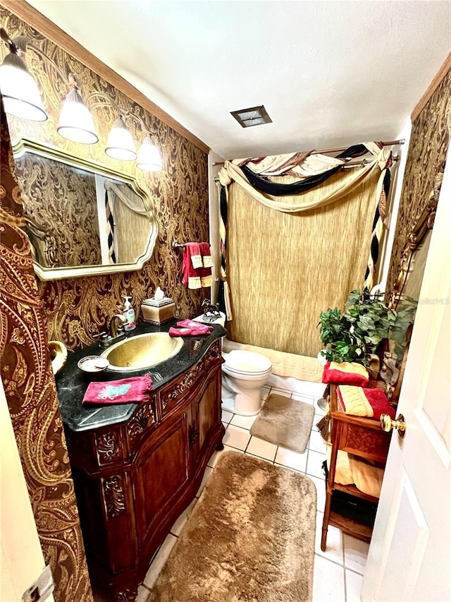 bathroom featuring vanity, tile patterned flooring, and toilet