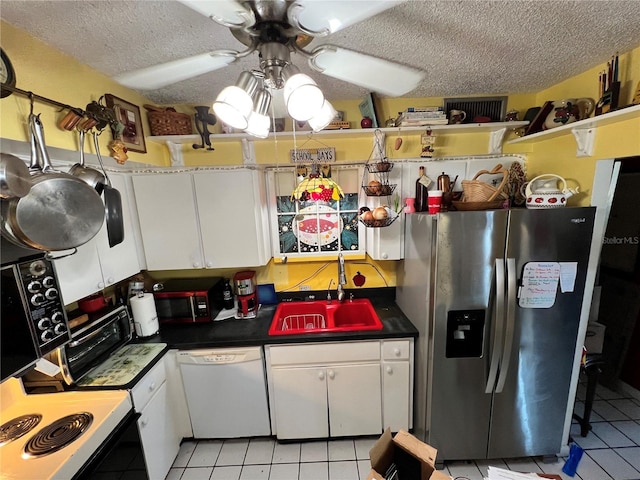 kitchen featuring white cabinetry, dishwasher, sink, stainless steel fridge, and ceiling fan