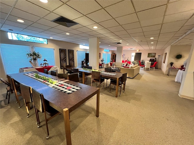 carpeted dining room featuring a paneled ceiling