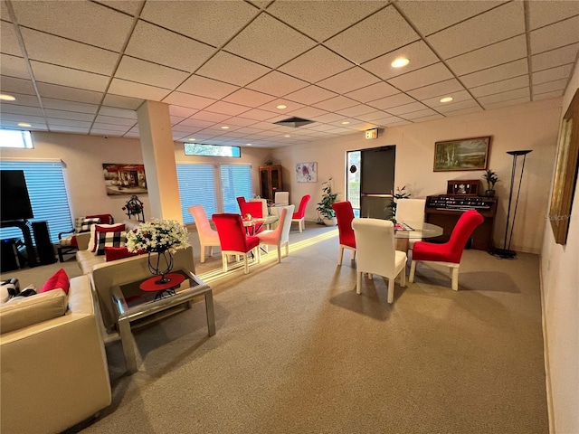 recreation room featuring carpet and a drop ceiling