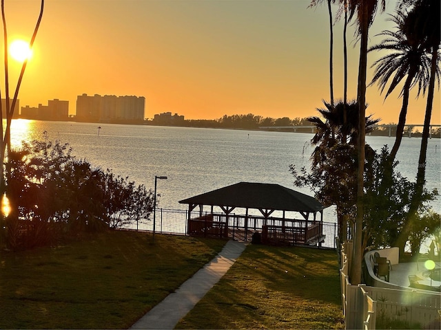 view of dock featuring a gazebo and a water view