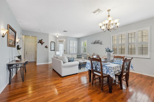 18819 Sunterra Dr, Land O Lakes, FL 34638 - dining space with a chandelier, light wood-style flooring, and baseboards