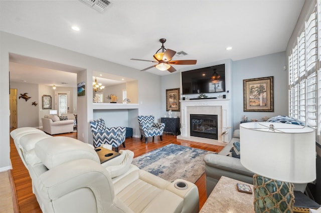 18819 Sunterra Dr, Land O Lakes, FL 34638 - living area featuring wood finished floors, a large fireplace, a ceiling fan, recessed lighting, and baseboards
