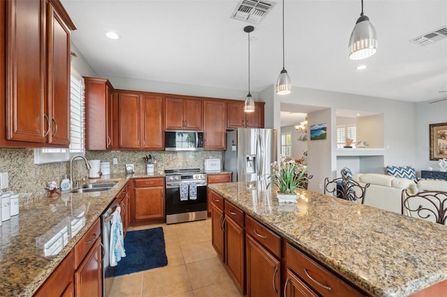18819 Sunterra Dr, Land O Lakes, FL 34638 - kitchen featuring stainless steel appliances, a sink, decorative backsplash, open floor plan, and light stone counters