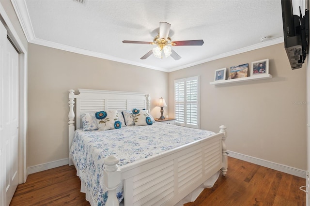 18819 Sunterra Dr, Land O Lakes, FL 34638 - bedroom with wood finished floors, baseboards, a closet, ornamental molding, and a textured ceiling