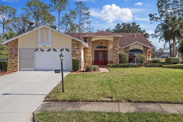 view of front of property with french doors, a garage, and a front yard