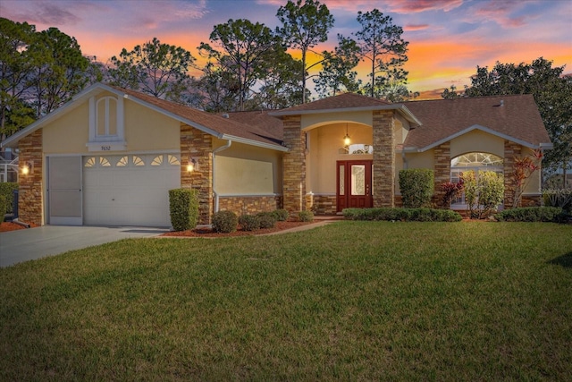 view of front facade featuring a garage and a lawn