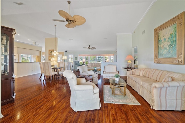 living room with dark wood-type flooring, a wealth of natural light, and ornamental molding