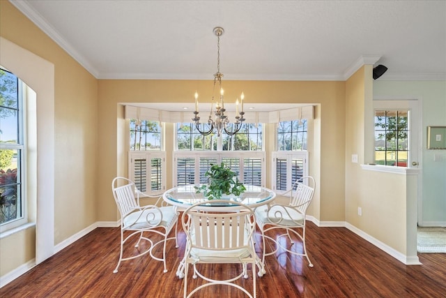 dining room with crown molding, dark hardwood / wood-style floors, and an inviting chandelier