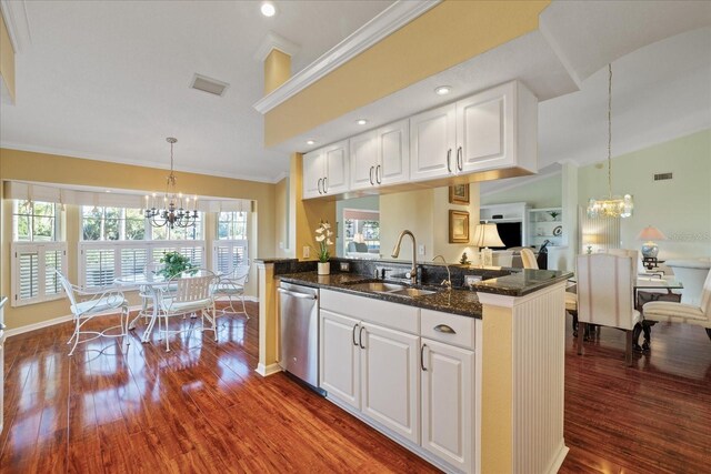 kitchen featuring sink, white cabinetry, an inviting chandelier, hanging light fixtures, and stainless steel dishwasher