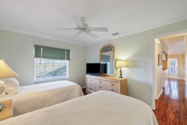 bedroom with multiple windows, crown molding, and dark hardwood / wood-style floors