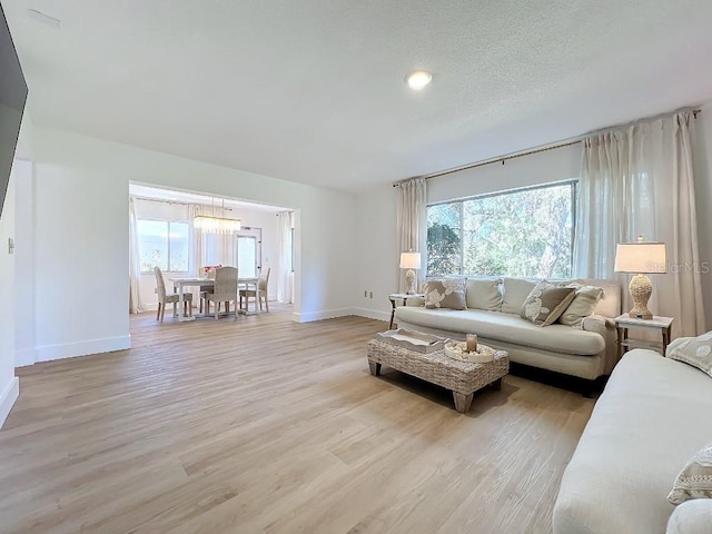 living room with light hardwood / wood-style floors and a textured ceiling