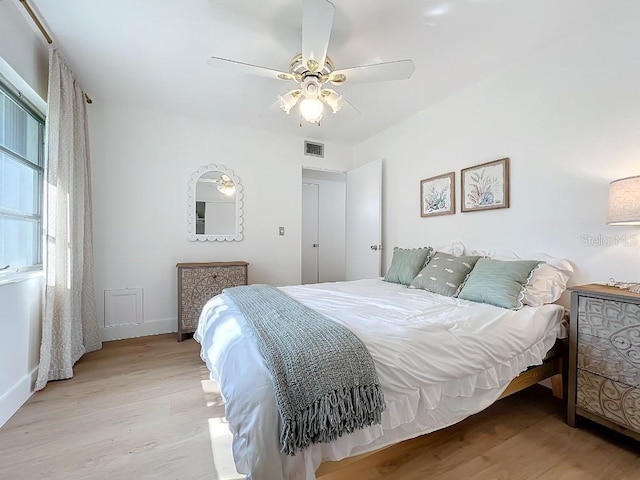 bedroom with light hardwood / wood-style flooring and ceiling fan