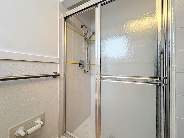 bathroom with a shower with door